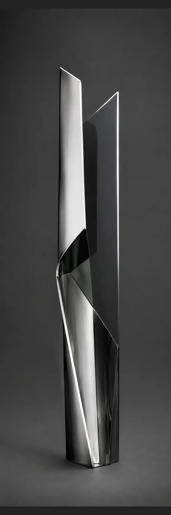 Folded chrome sheet intersecting a dark glass fin.